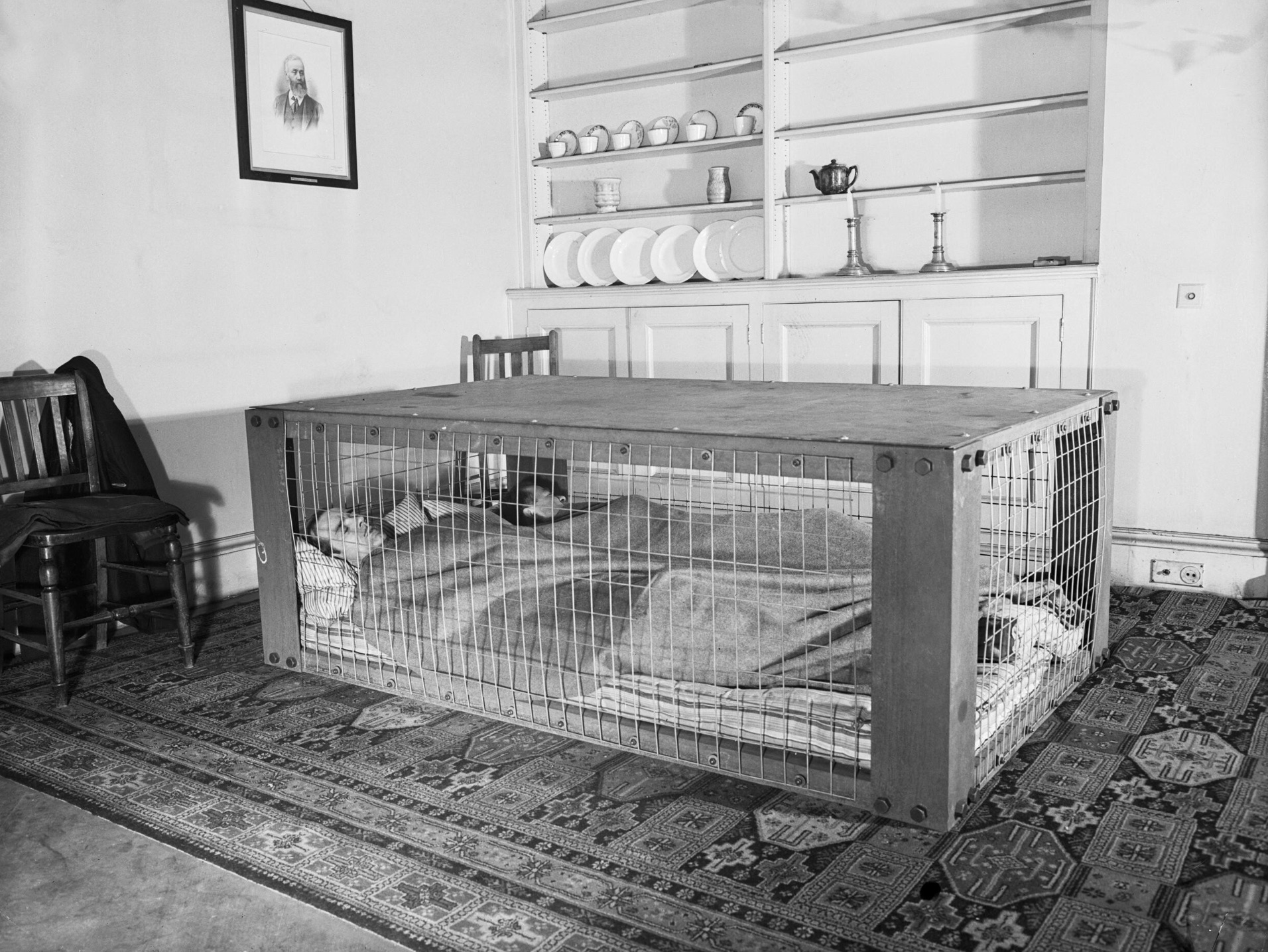A couple demonstrating the use of a Morrison shelter, thought to protect against nuclear fallout 